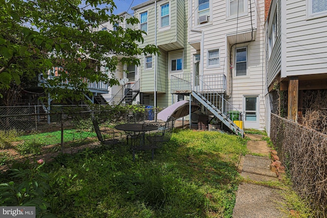 rear view of property with stairway