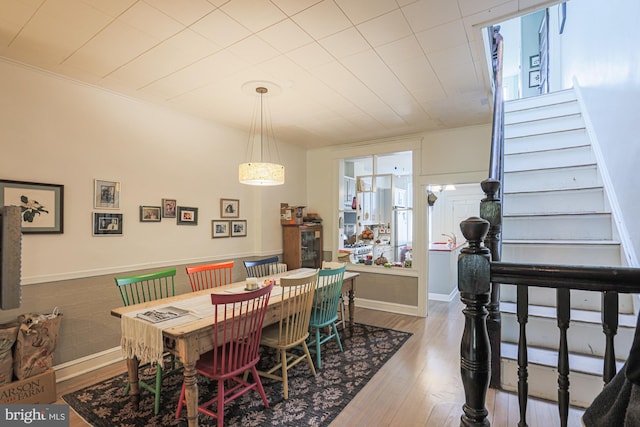dining space with stairway and wood finished floors