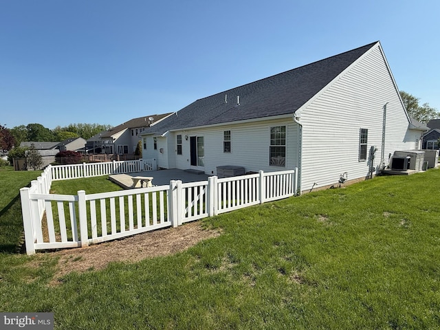 rear view of house with a patio area and roof with shingles