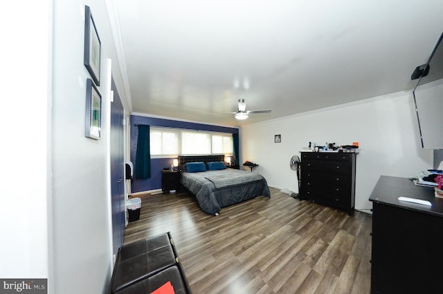 bedroom featuring dark wood-style flooring, ornamental molding, and ceiling fan