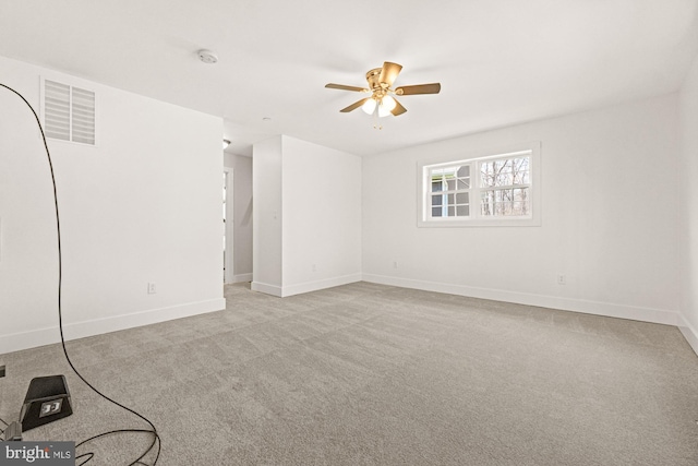 carpeted empty room featuring ceiling fan, baseboards, and visible vents