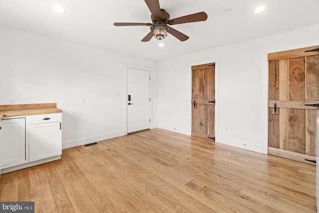 interior space with recessed lighting, light wood-type flooring, visible vents, and ceiling fan