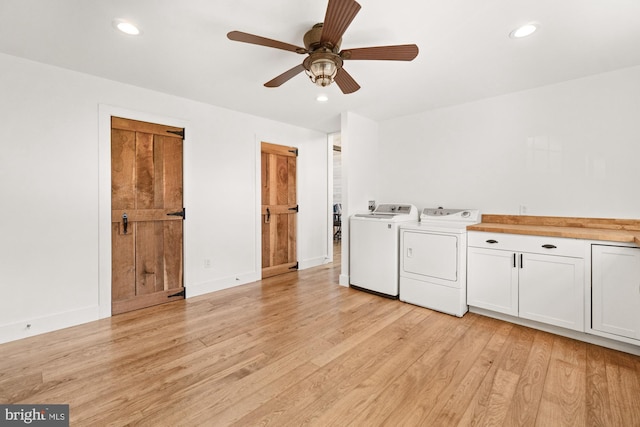 laundry area with ceiling fan, cabinet space, light wood-style flooring, washing machine and dryer, and recessed lighting