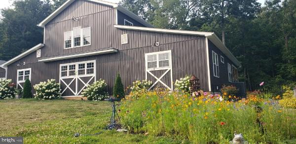 view of barn with a lawn