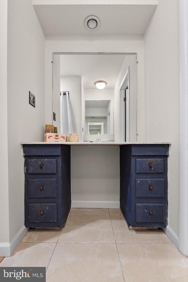 bathroom featuring tile patterned floors and baseboards
