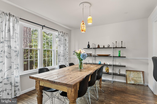 dining room with hardwood / wood-style floors and baseboards