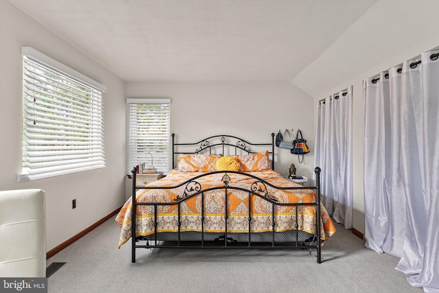 bedroom with carpet floors, visible vents, and baseboards