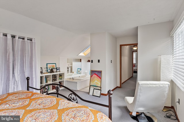 carpeted bedroom featuring vaulted ceiling and baseboards