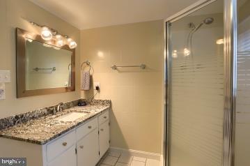 20 Tower Rd, Dillsburg, PA 17019 - full bath featuring vanity, tile patterned flooring, and a shower with shower door