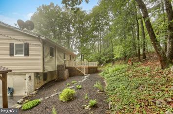 20 Tower Rd, Dillsburg, PA 17019 - view of yard with stairs, a wooden deck, and an attached garage