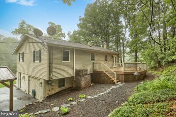 20 Tower Rd, Dillsburg, PA 17019 - back of house featuring a deck, an attached garage, and stairs