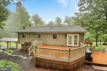 20 Tower Rd, Dillsburg, PA 17019 - back of house featuring french doors, a wooden deck, a chimney, and a gazebo