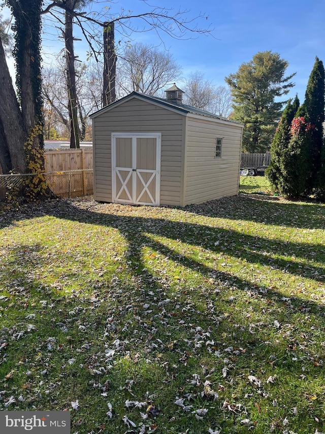 view of shed with fence
