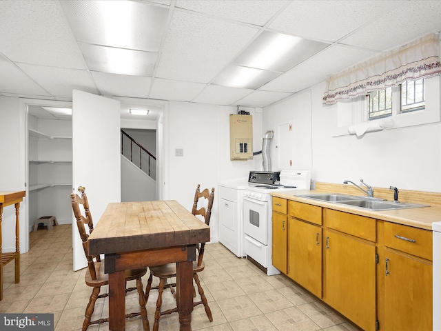 kitchen with electric range, washer / clothes dryer, a paneled ceiling, a sink, and light countertops