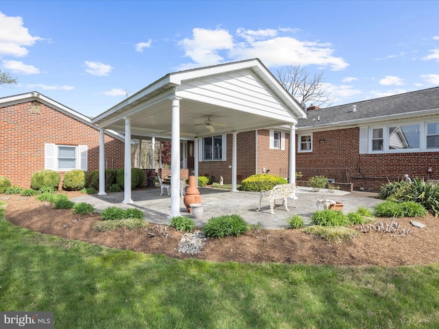 rear view of house with a patio, ceiling fan, and brick siding