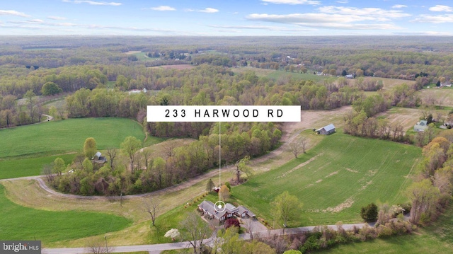 birds eye view of property featuring a forest view