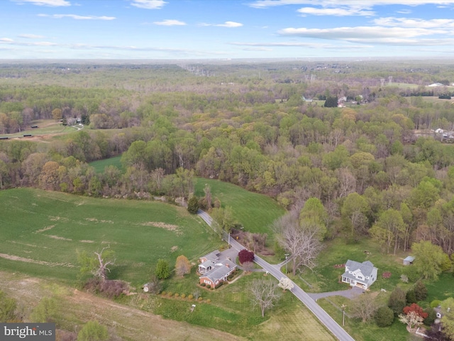 birds eye view of property featuring a wooded view