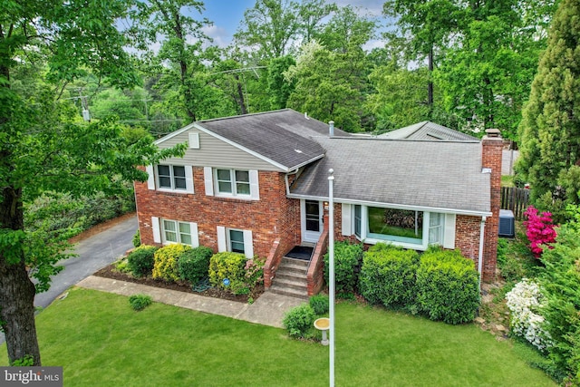 2426 Chestnut St, Falls Church, VA 22043 - tri-level home with a shingled roof, brick siding, and a chimney