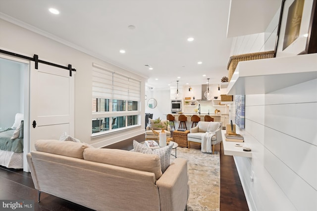 141 W St Unit 304, Annapolis, MD 21401 - living room featuring a barn door, recessed lighting, ornamental molding, and dark wood-style floors