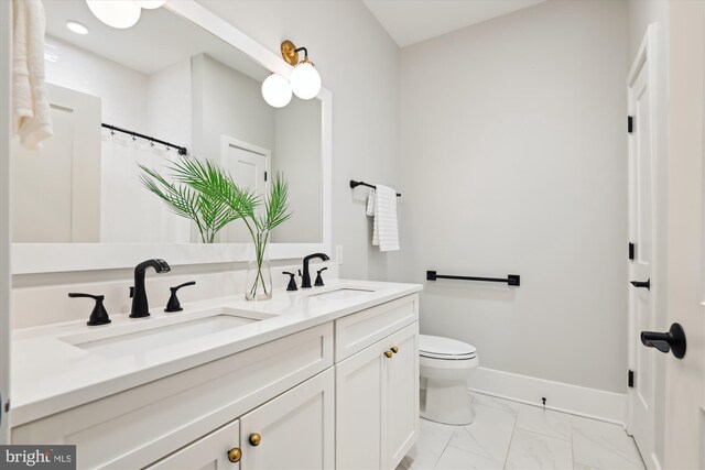 141 W St Unit 304, Annapolis, MD 21401 - bathroom with marble finish flooring, double vanity, toilet, and baseboards