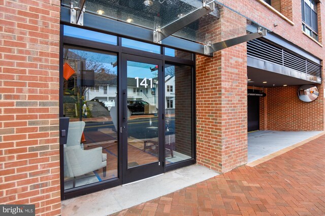 141 W St Unit 304, Annapolis, MD 21401 - view of exterior entry featuring brick siding and french doors