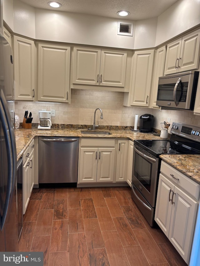 1805 S Crystal Dr S Unit 1109S, Arlington, VA 22202 - kitchen with appliances with stainless steel finishes, a sink, backsplash, light stone countertops, and recessed lighting