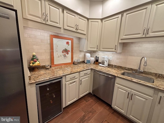 1805 S Crystal Dr S Unit 1109S, Arlington, VA 22202 - kitchen featuring beverage cooler, appliances with stainless steel finishes, a sink, tasteful backsplash, and light stone counters