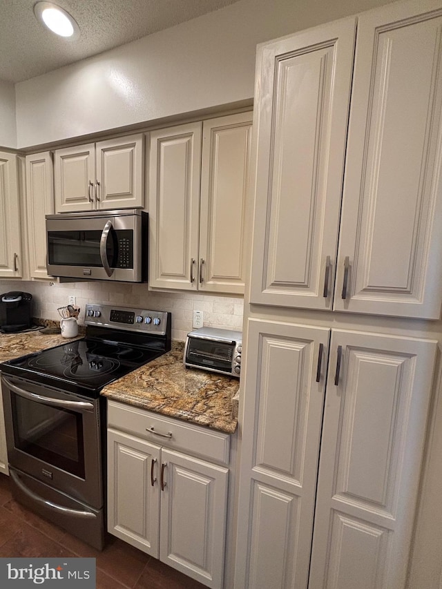 1805 S Crystal Dr S Unit 1109S, Arlington, VA 22202 - kitchen with appliances with stainless steel finishes, decorative backsplash, and light stone counters