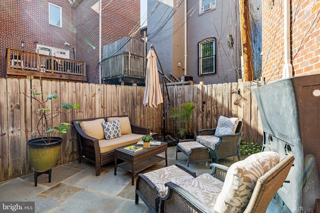 view of patio / terrace featuring an outdoor hangout area and a fenced backyard