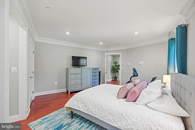 bedroom featuring recessed lighting, baseboards, crown molding, and wood finished floors