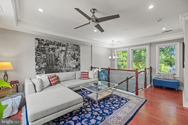 living area featuring visible vents, crown molding, wood finished floors, recessed lighting, and a ceiling fan