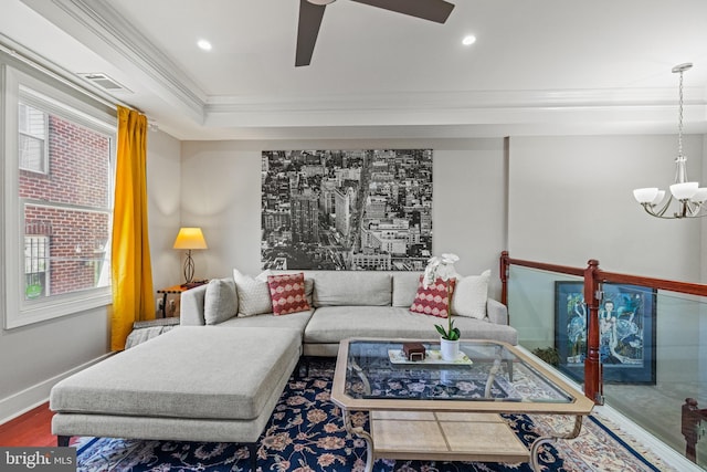 living room with visible vents, crown molding, baseboards, ceiling fan with notable chandelier, and recessed lighting