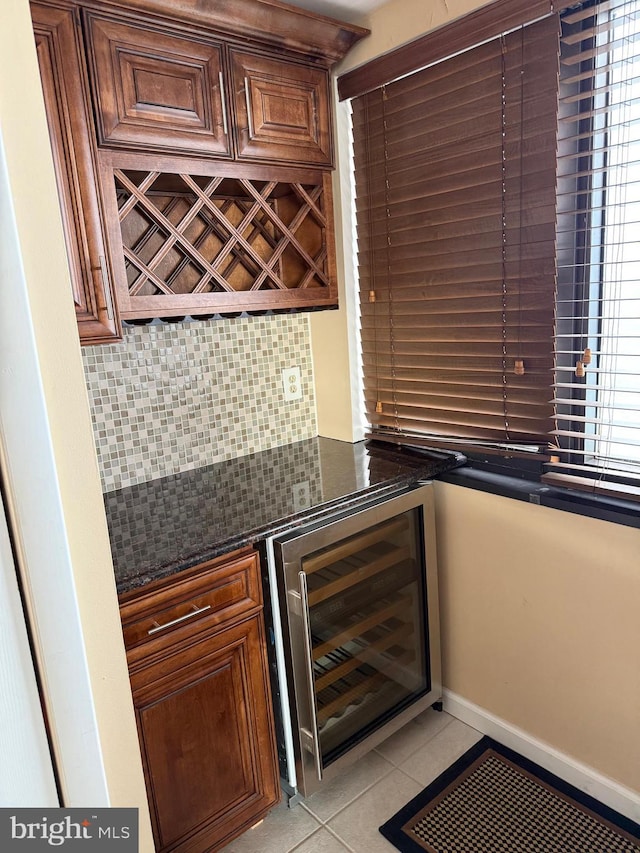 bar featuring decorative backsplash, beverage cooler, and light tile patterned floors