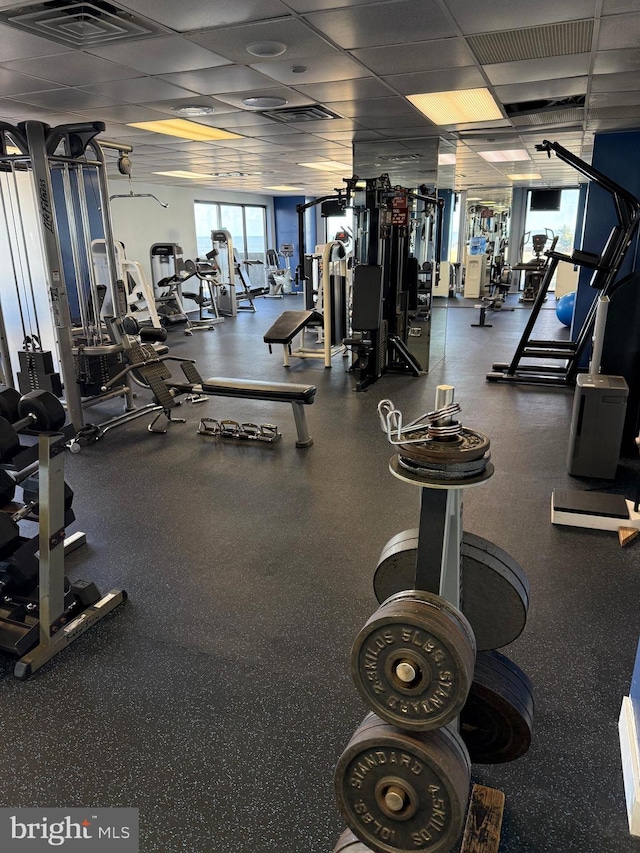 workout area featuring visible vents and a paneled ceiling