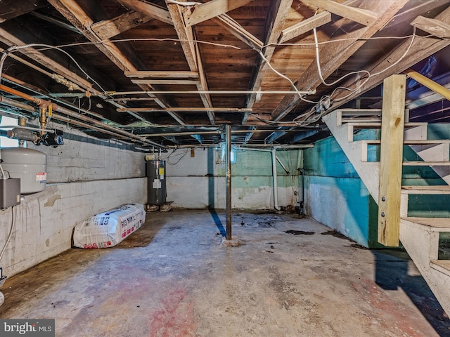 unfinished basement featuring stairway and water heater