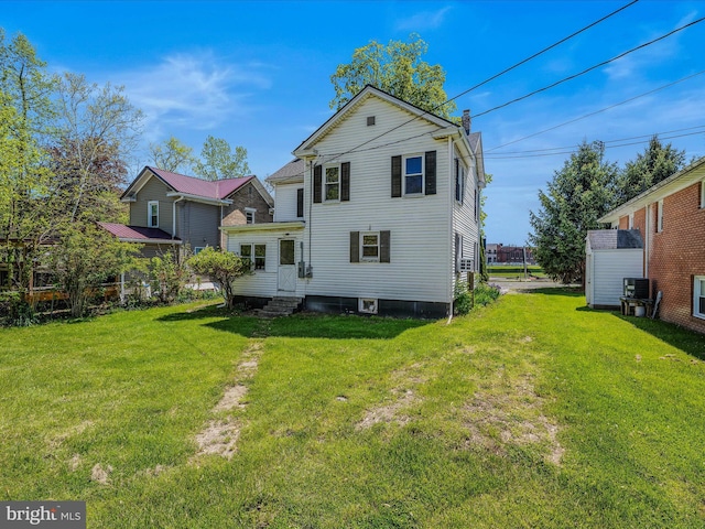 back of property with a lawn, entry steps, and central air condition unit