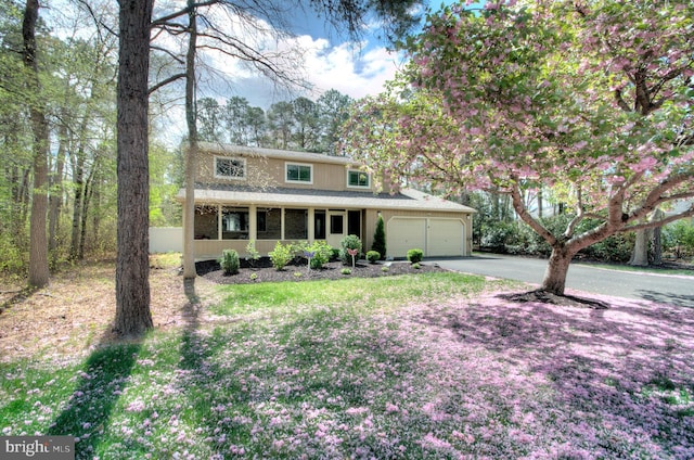 view of front facade with an attached garage and aphalt driveway