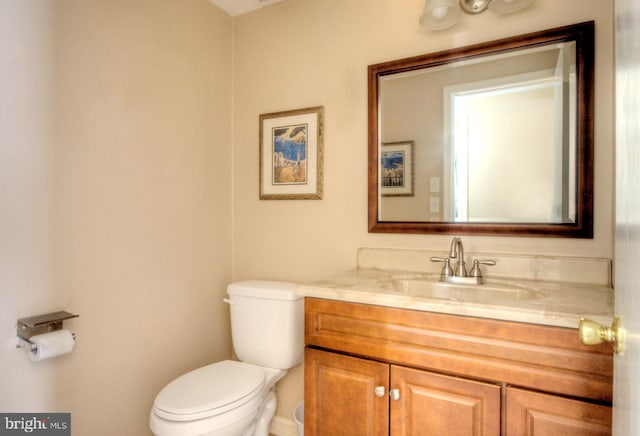 bathroom with toilet and vanity