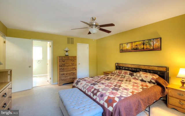 bedroom with light colored carpet, a ceiling fan, and visible vents