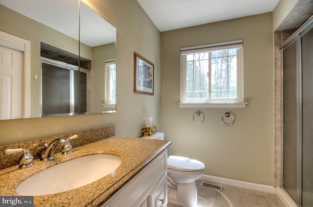 bathroom featuring visible vents, a shower stall, tile patterned flooring, and vanity