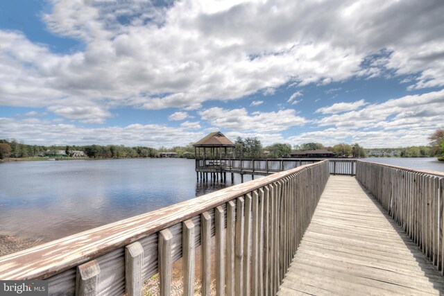 dock area with a water view and a gazebo