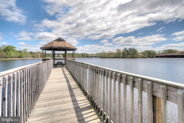 view of dock with a gazebo and a water view