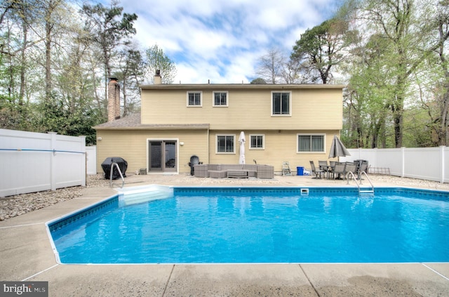 view of pool with area for grilling, a fenced in pool, an outdoor hangout area, a fenced backyard, and a patio