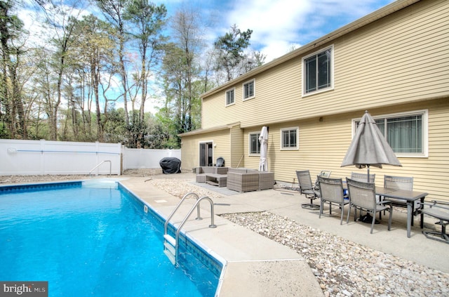 view of swimming pool featuring a patio, outdoor lounge area, a fenced backyard, and a fenced in pool