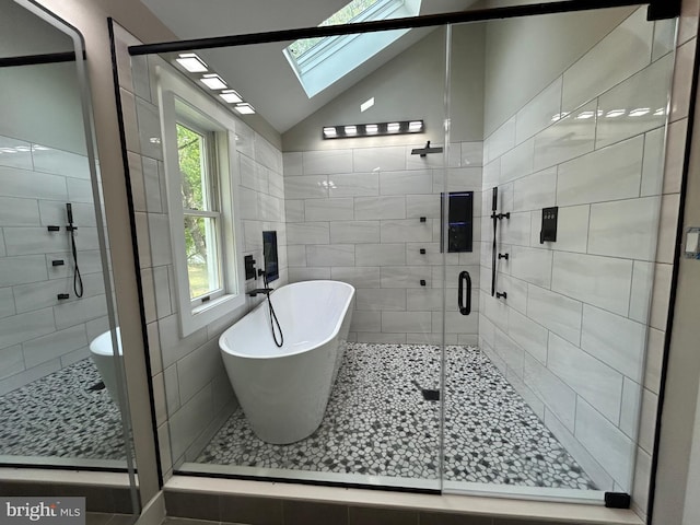849 Glenn Cir, Wayne, PA 19087 - bathroom with a skylight, vaulted ceiling, a freestanding tub, and a stall shower