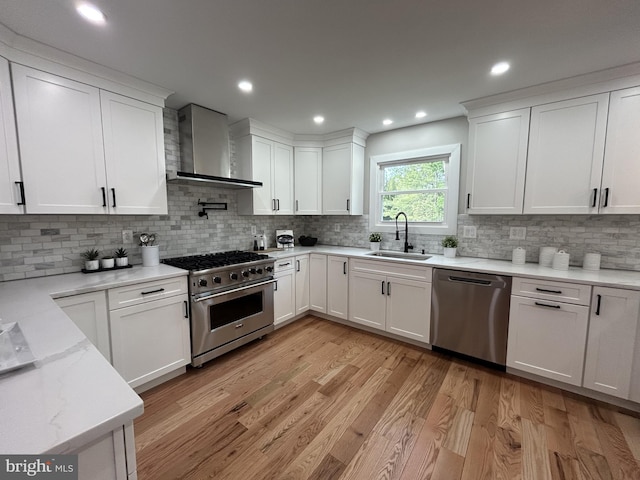 849 Glenn Cir, Wayne, PA 19087 - kitchen featuring wall chimney exhaust hood, stainless steel appliances, a sink, white cabinetry, and recessed lighting
