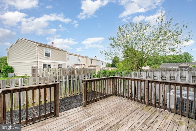 deck with a residential view and central AC unit