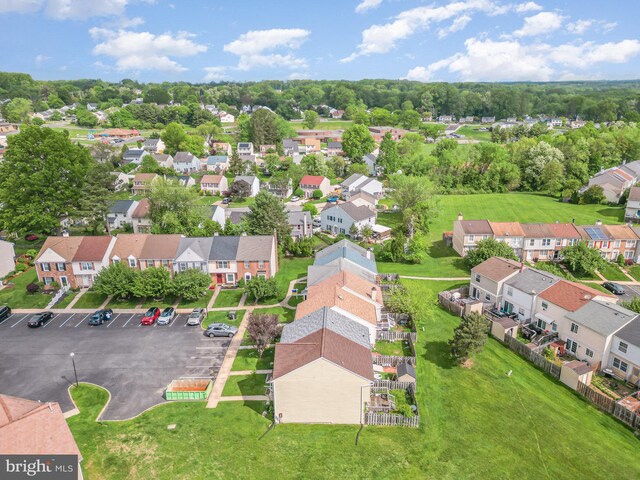 aerial perspective of suburban area featuring a tree filled landscape