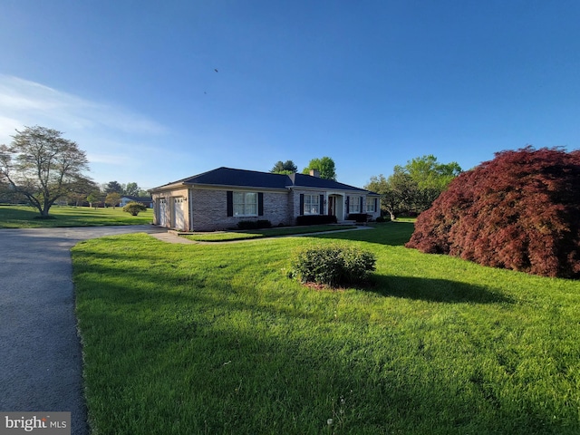 7198 Allegheny Dr, Frederick, MD 21702 - view of front of house featuring a garage, a front lawn, aphalt driveway, and a chimney