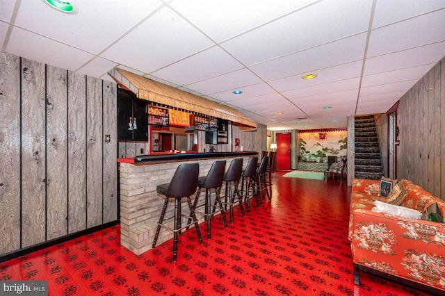 7198 Allegheny Dr, Frederick, MD 21702 - bar with bar, wood walls, a paneled ceiling, carpet, and stairway